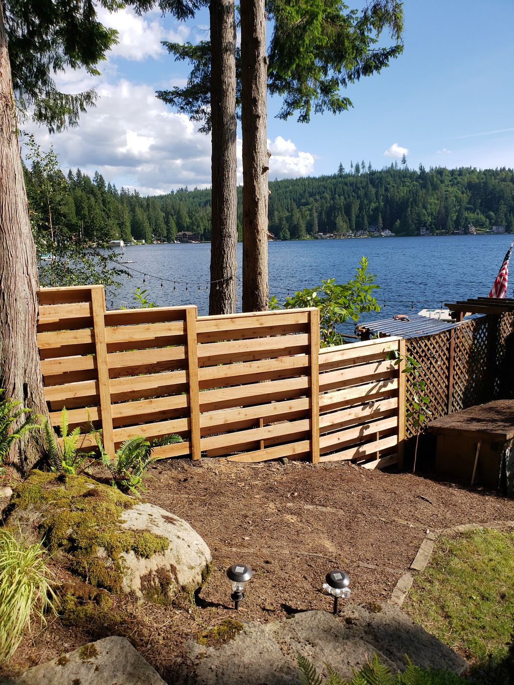 Horizontal cedar fence on a lakefront lot with new landscaping