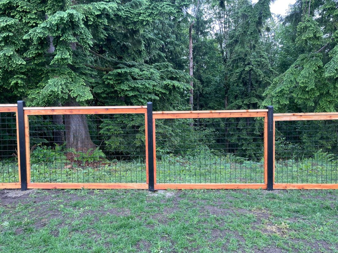 Black welded hogwire panels with cedar framing and black steel posts